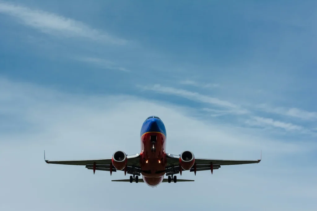 Head-on view of a blue and red Southwest Airlines Boeing 737 airplane landing