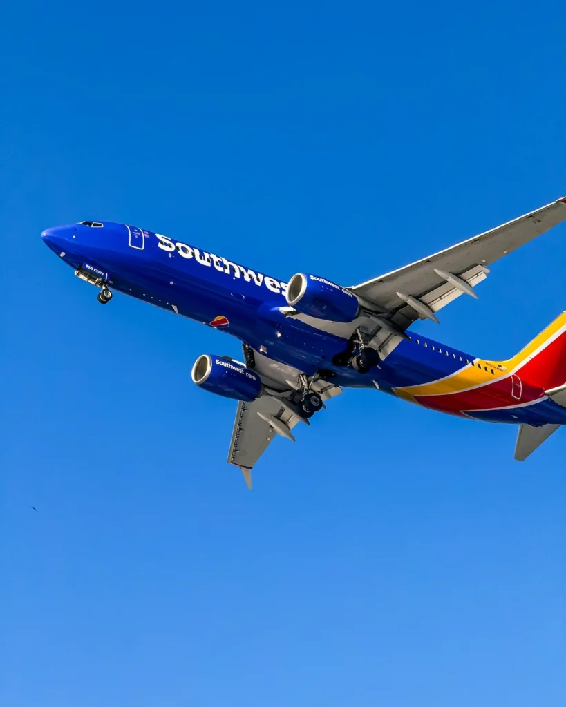 Southwest Airlines Boeing 737 plane climbing steeply into a clear blue sky after takeoff