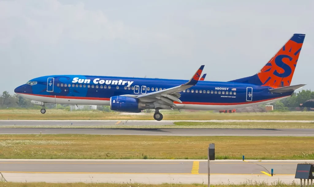 A Sun Country Airlines Boeing 737-800 airplane approaching the runway for landing