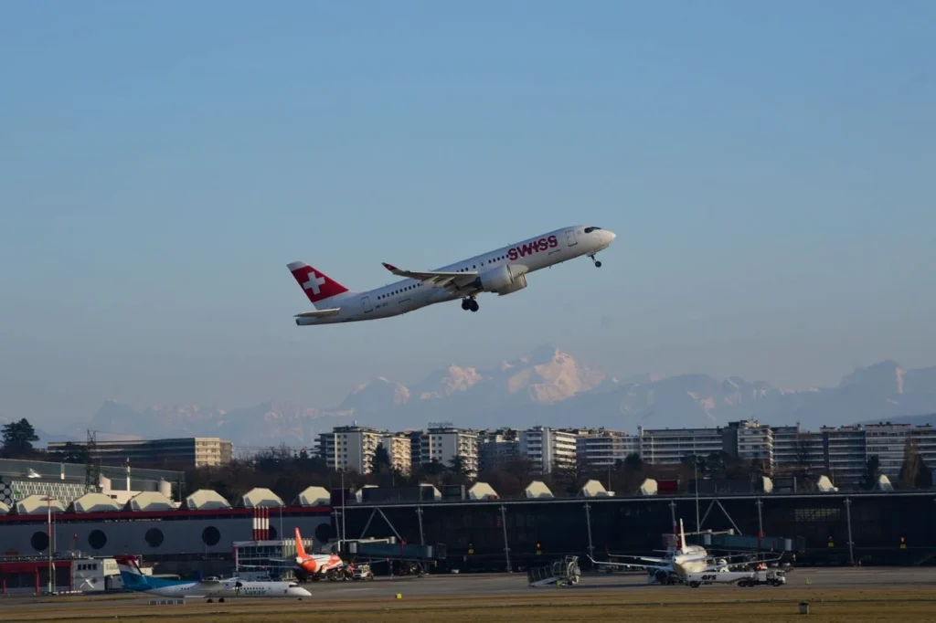 A SWISS International Air Lines Airbus A220 passenger airplane climbing into the air after taking off