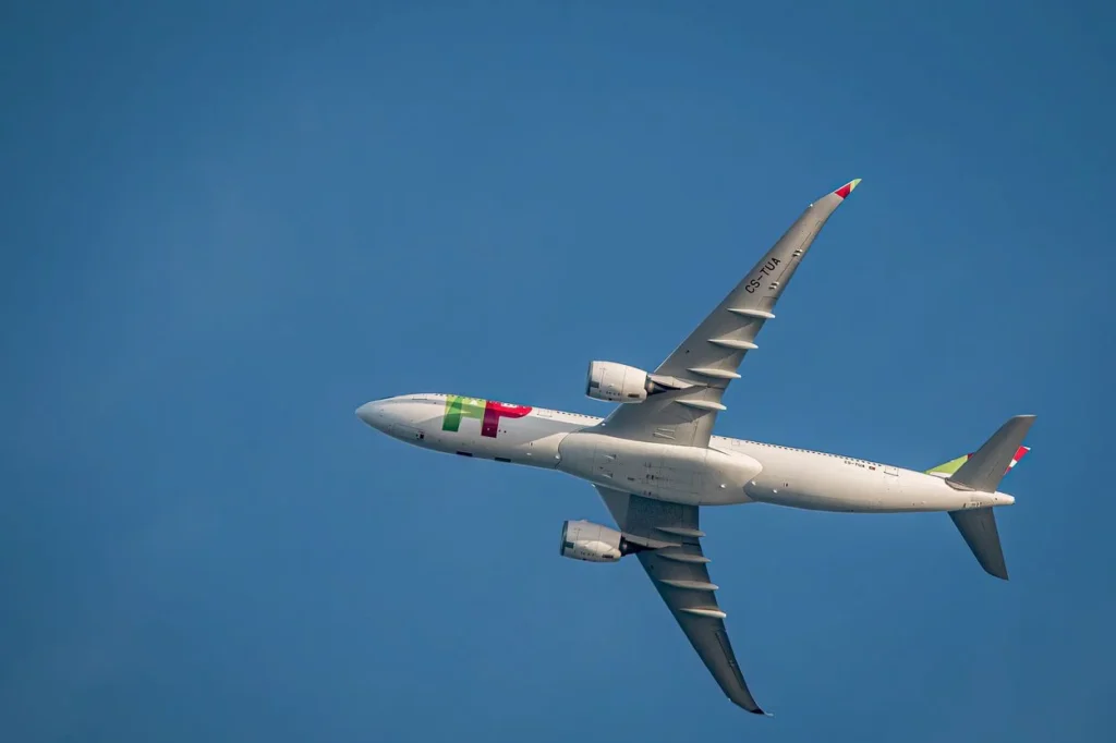 Underbelly view of a white TAP Air Portugal Airbus A330-900neo passenger jet