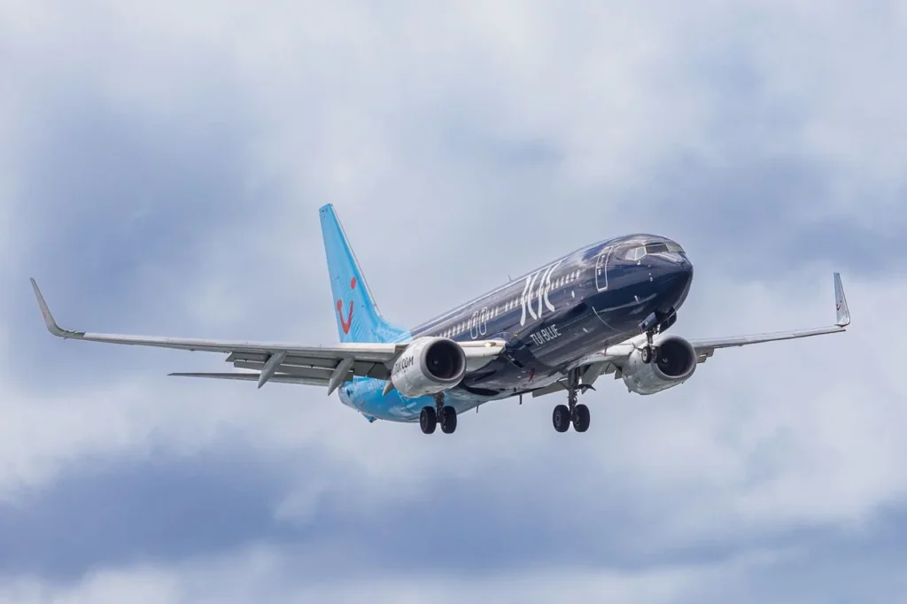A TUI fly Boeing 737-800 commercial passenger airplane sporting a dark blue TUI BLUE