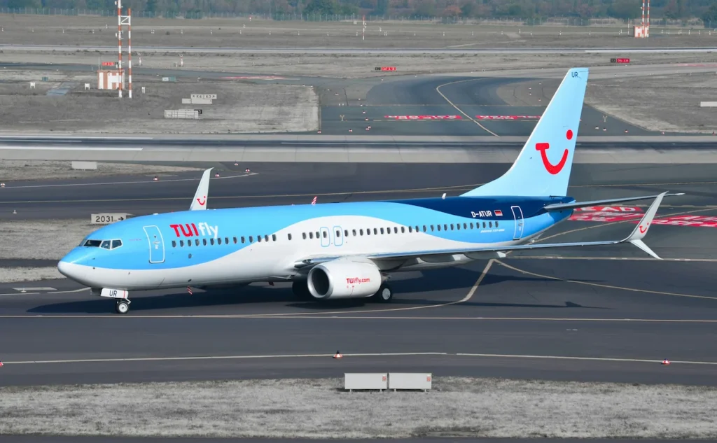TUI fly Boeing 737-800 aircraft taxiing on an airport runway