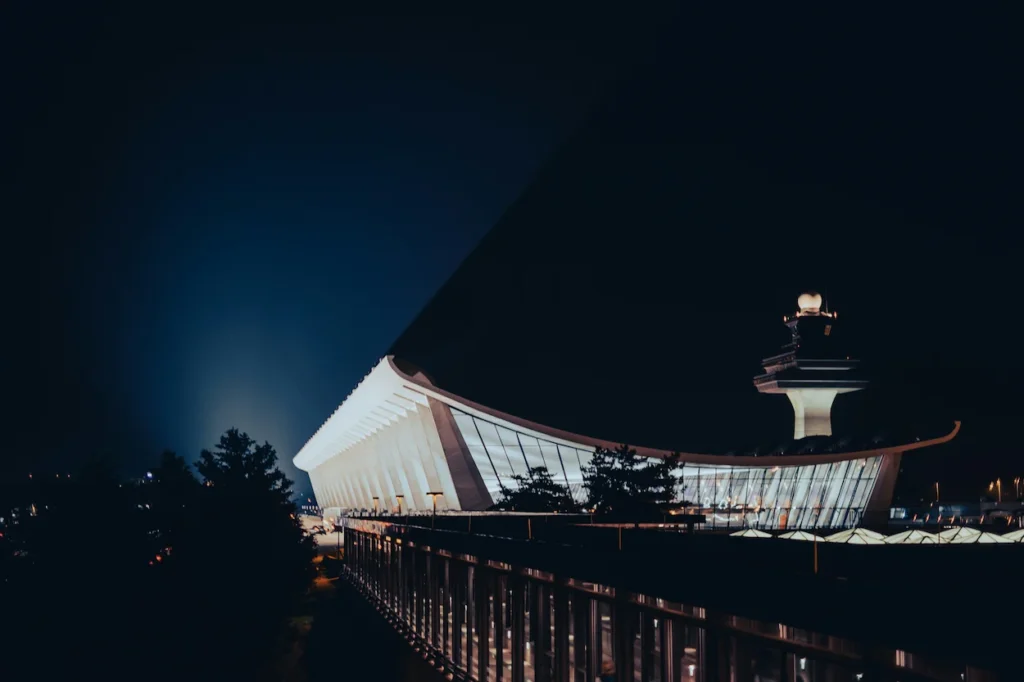 Eero Saarinen's historic main terminal and control tower illuminated at night