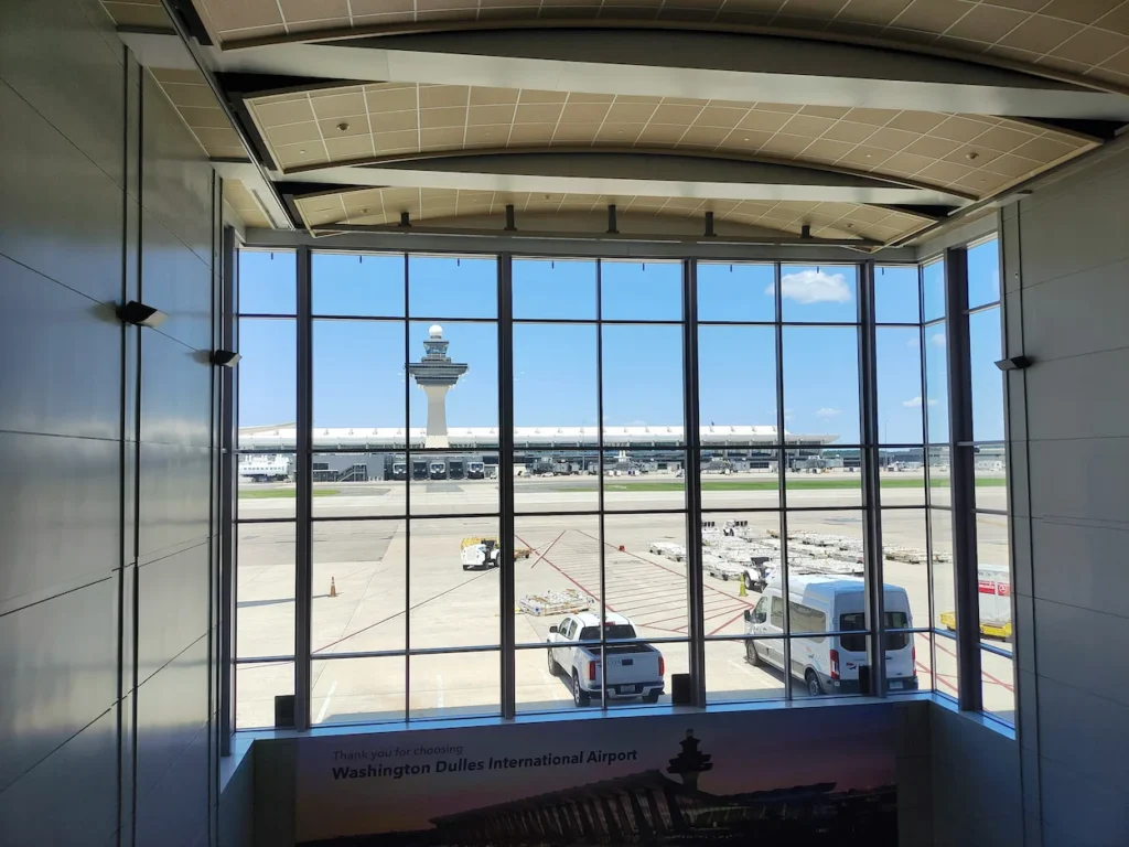 Washington Dulles International Airport terminal and control tower viewed through a large window