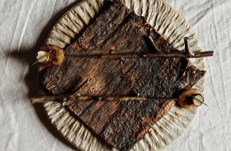 Abalone smoked in paperbark with boab, geraldton wax and sea urchin hot sauce.