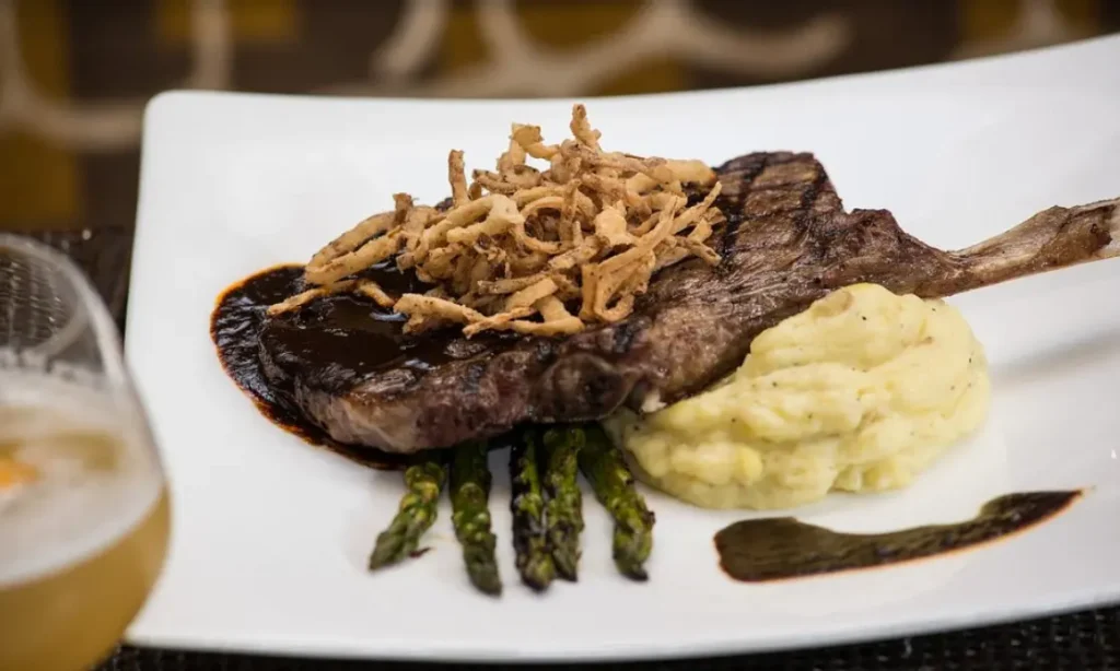 10oz Rib Eye: Dutchess potato, Texas honey ancho sauce, sweet onion cloud, grilled asparagus