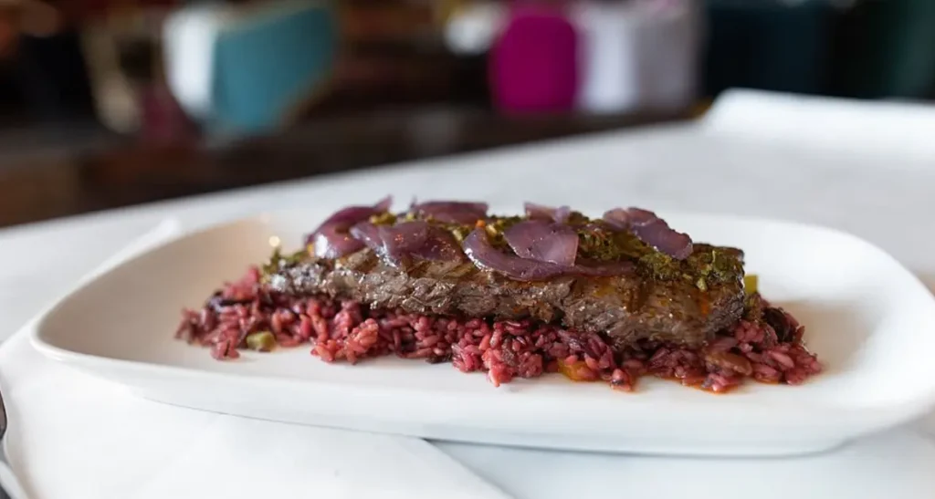 Wood-grilled skirt steak, congri, cherry, bacon sofrito, balsamic onions, chimichurri