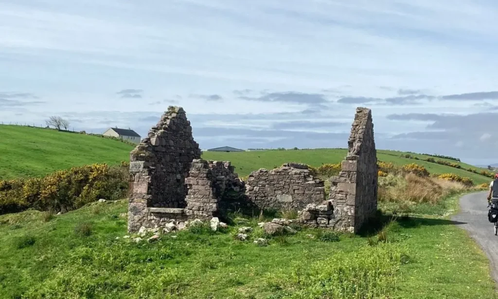 A ruined stone structure stands along the Great Western Greenway.