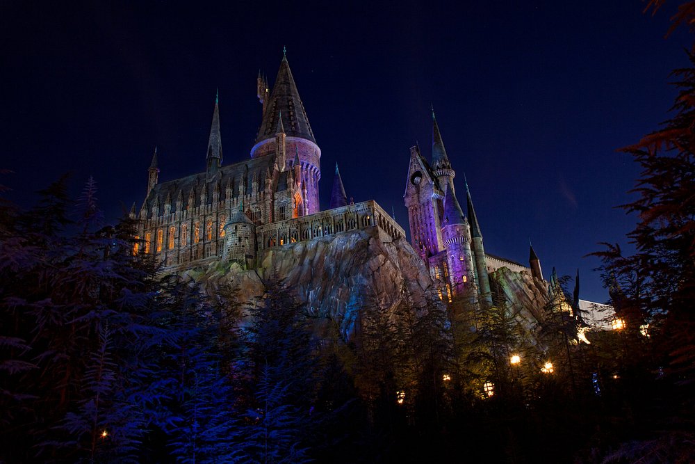 Hogwarts Castle illuminated at night in The Wizarding World of Harry Potter, Universal Studios.