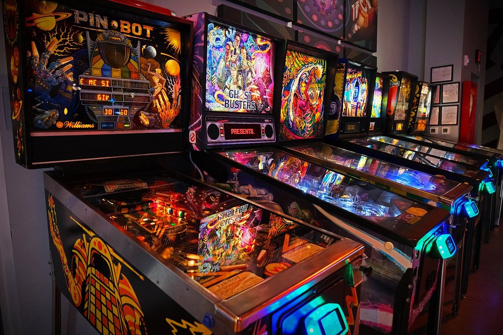 Row of colorful pinball machines at Two Bit Circus in Los Angeles.