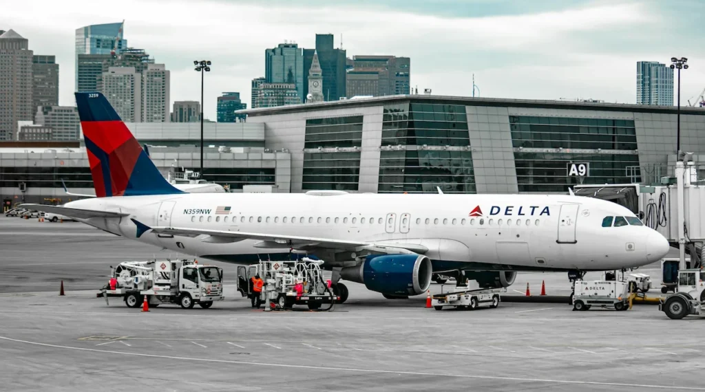 Delta Air Lines Airbus A320 parked at an airport terminal gate being serviced