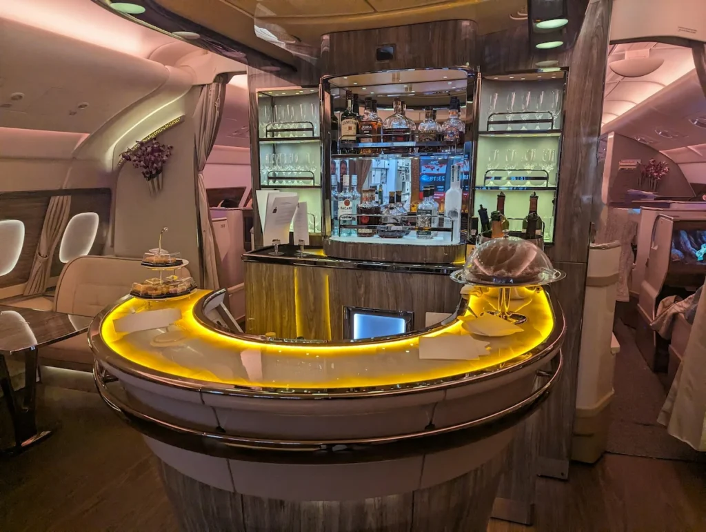 Emirates Airbus A380 onboard lounge bar with curved horseshoe counter and premium liquors