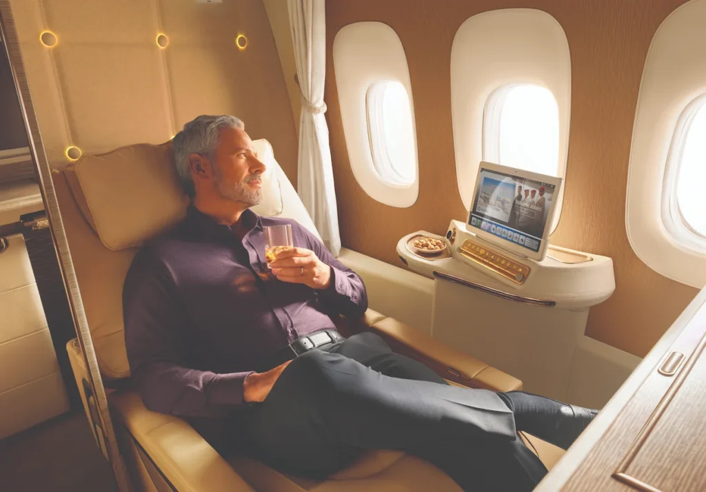 Man relaxing in an Emirates Boeing 777 first class private suite