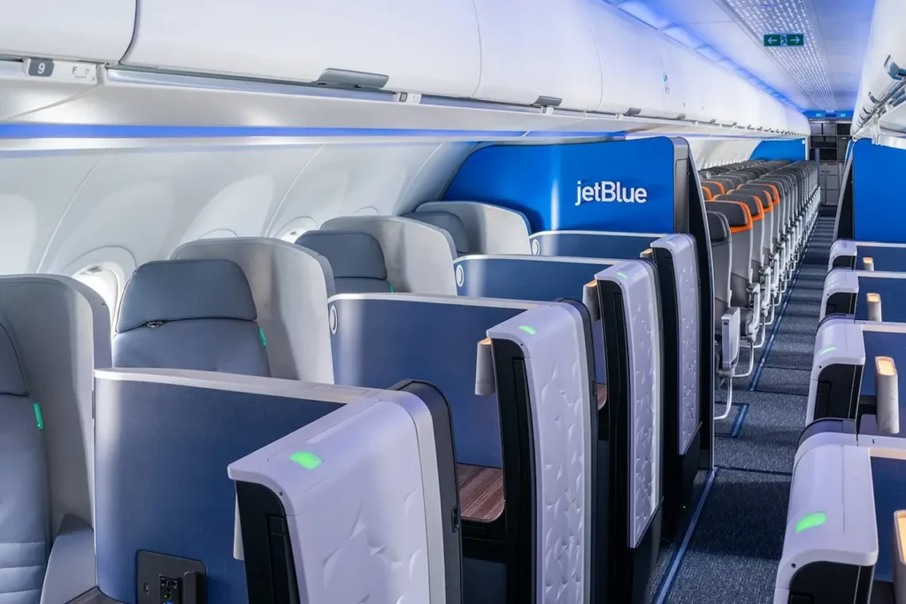 JetBlue Mint business class cabin with private suites featuring sliding doors on an Airbus airplane