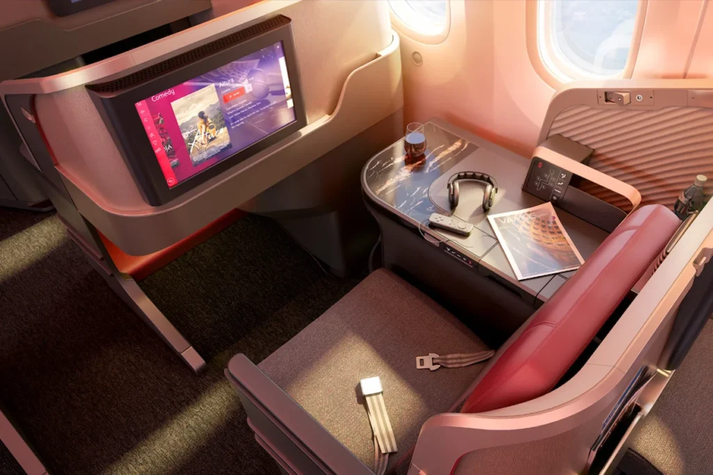 LATAM Airlines Premium Business suite with a large entertainment screen next to a window