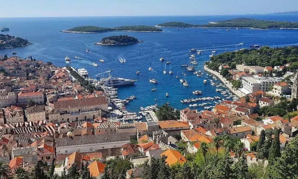 A scenic view of Hvar’s harbor filled with boats and surrounded by historic buildings.