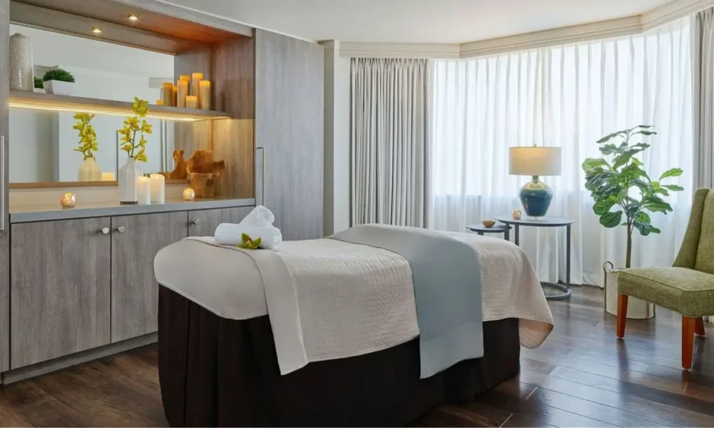 A serene spa room with soft lighting and a massage table at The Whitley.
