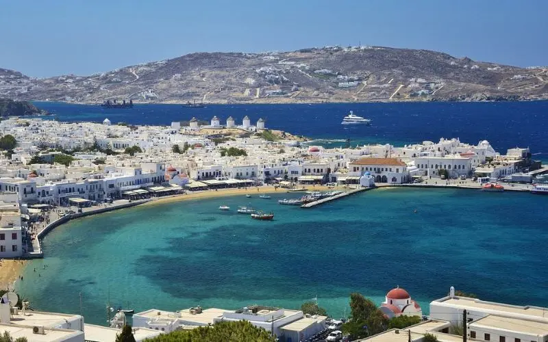 Whitewashed houses and a blue bay on the island of Mykonos, Greece.