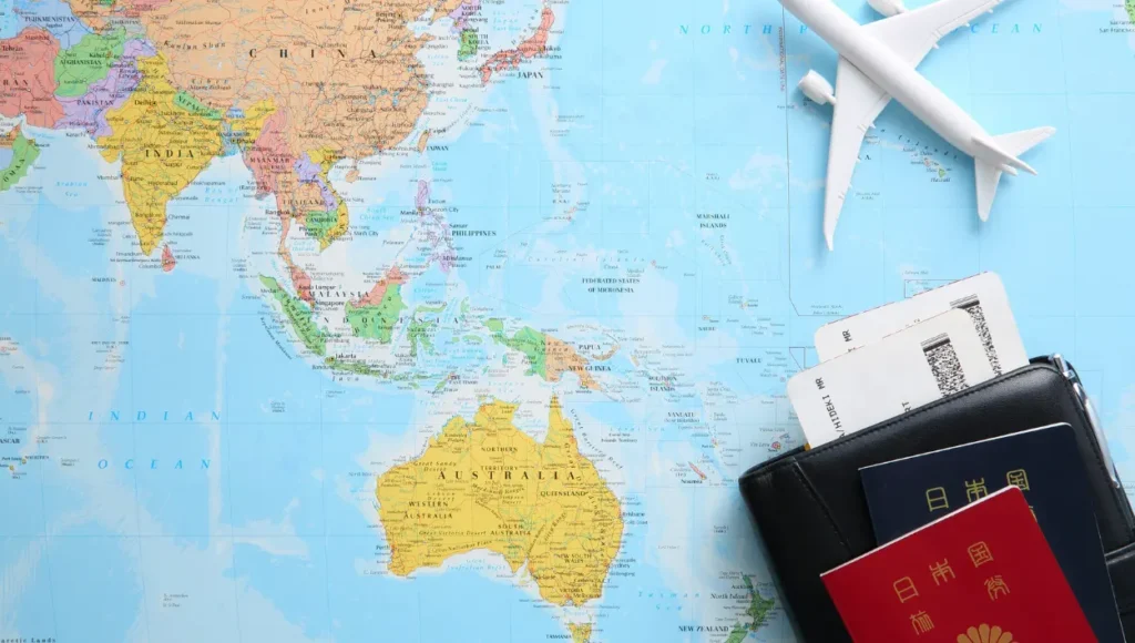 A map, passport, flight tickets, and a miniature airplane