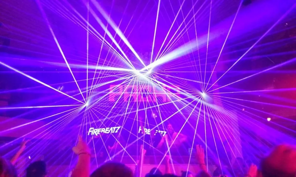 Crowds enjoy a vibrant laser light show at Pacha in Ibiza.