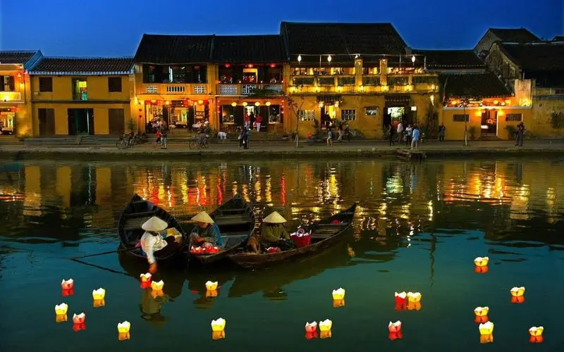 Boats and lanterns float on the river in Hoi An, Vietnam.