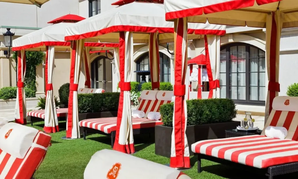Elegant red and white cabanas with striped lounge chairs at The St. Regis Atlanta.