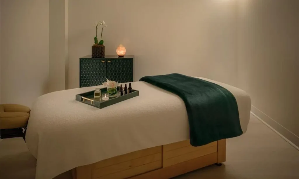 Cozy massage room with soft lighting and plush bedding at The Starling Atlanta Midtown.