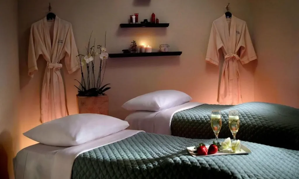 Intimate spa room with twin massage tables and robes on the wall at Atlanta Marriott Marquis.