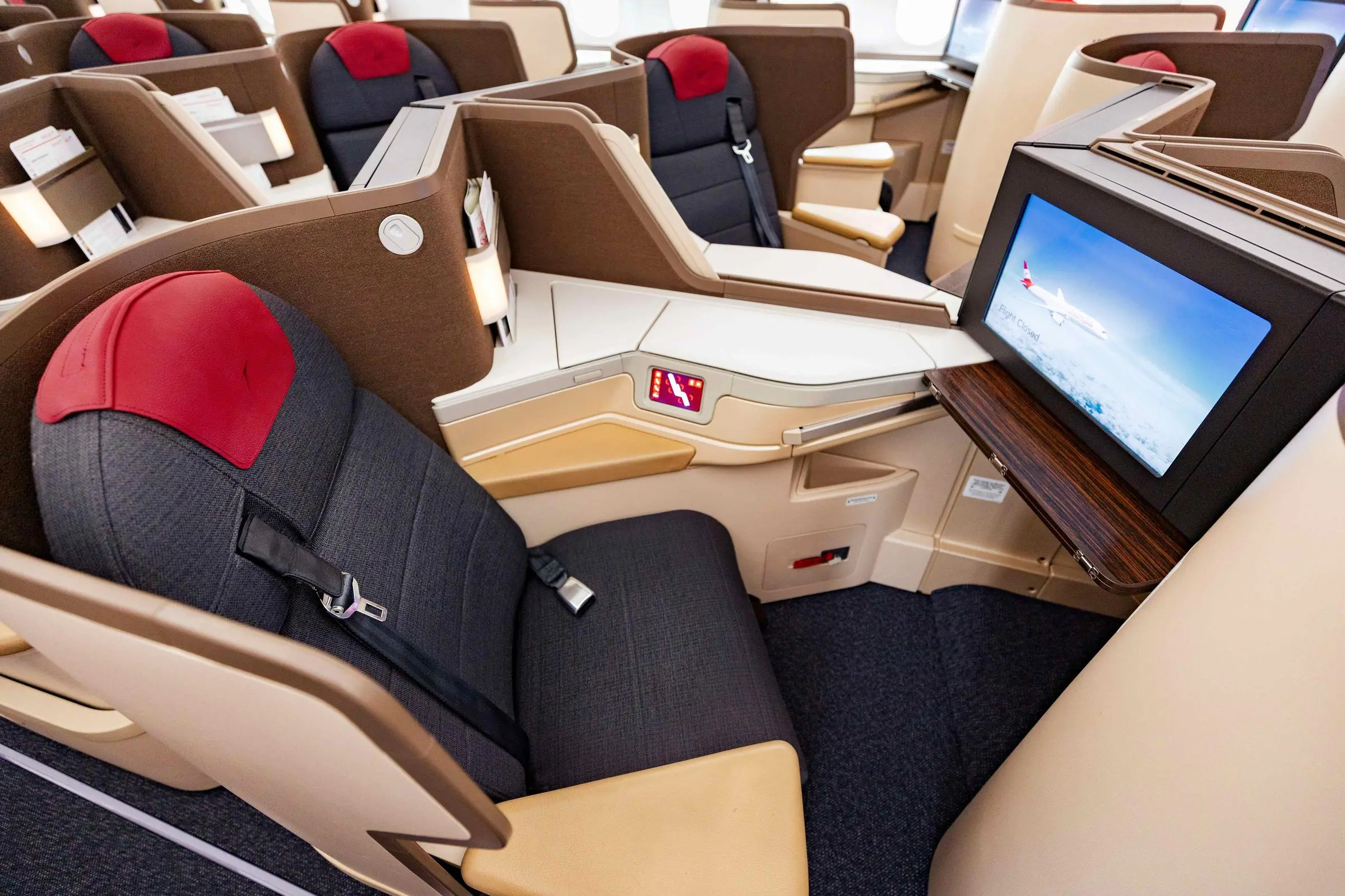Austrian Airlines 787 business class cabin with entertainment screens and reverse herringbone layout