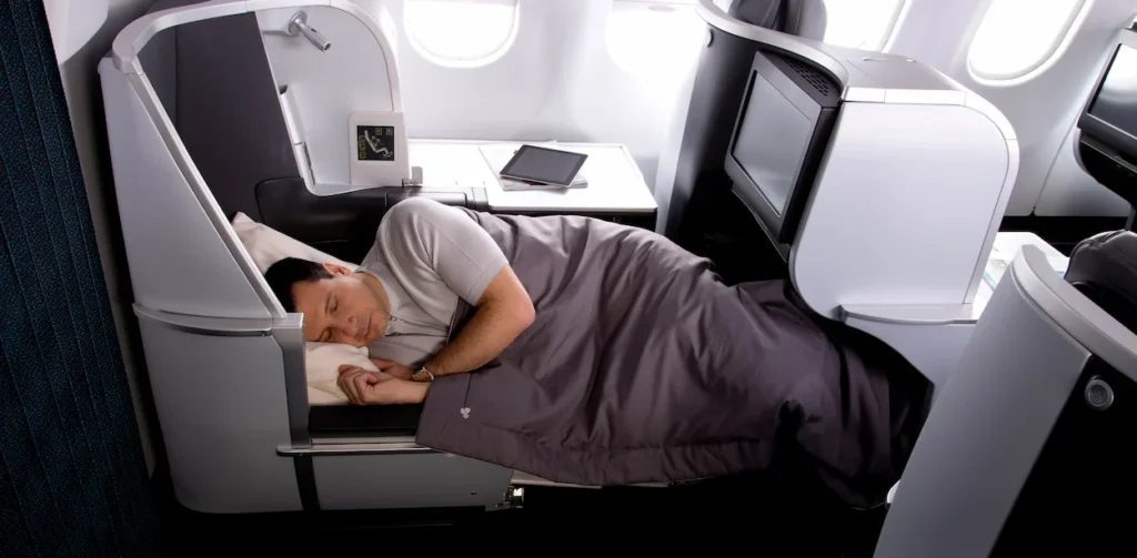 A passenger sleeping in an Aer Lingus lie-flat pod seat