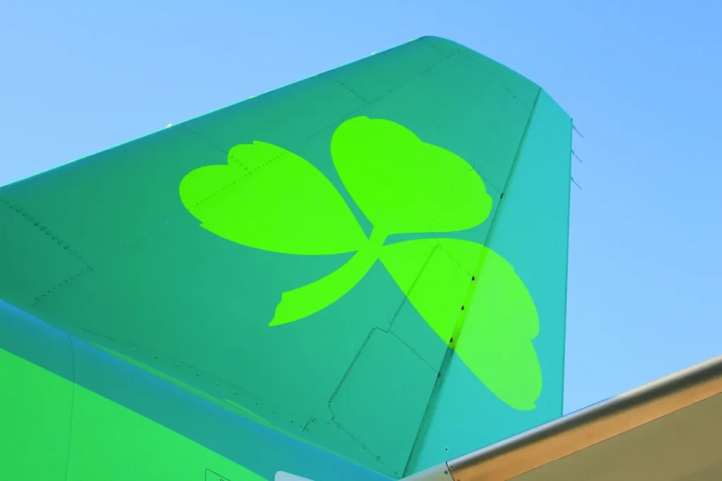 An Aer Lingus airplane tail featuring the green shamrock logo