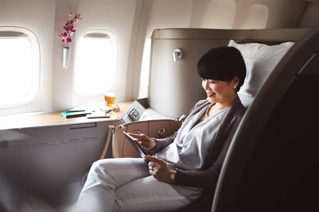 Passenger relaxing inside a spacious Cathay Pacific First Class suite cabin