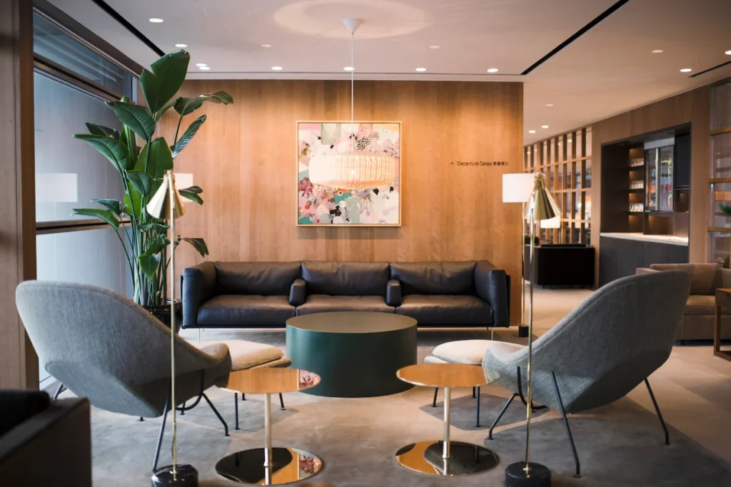 The Pier Business Class Lounge with warm wood paneling and residential-style seating