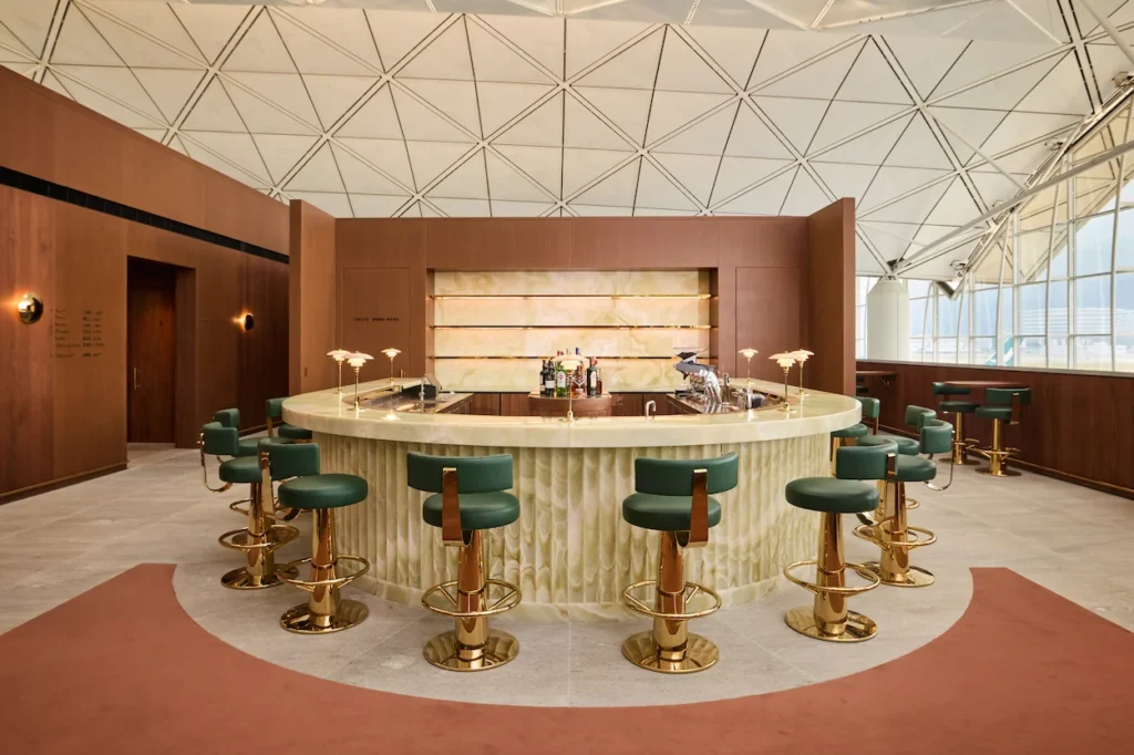 Luxury circular bar with green leather stools inside the Cathay Pacific First Class airport lounge
