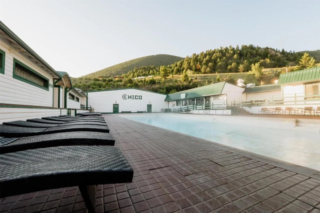Outdoor hot springs pool at Chico Hot Springs Resort with mountain views