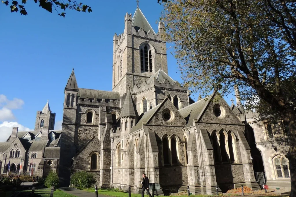 Exterior view of Christ Church Cathedral in Dublin showing its historic stone towers under a blue sky