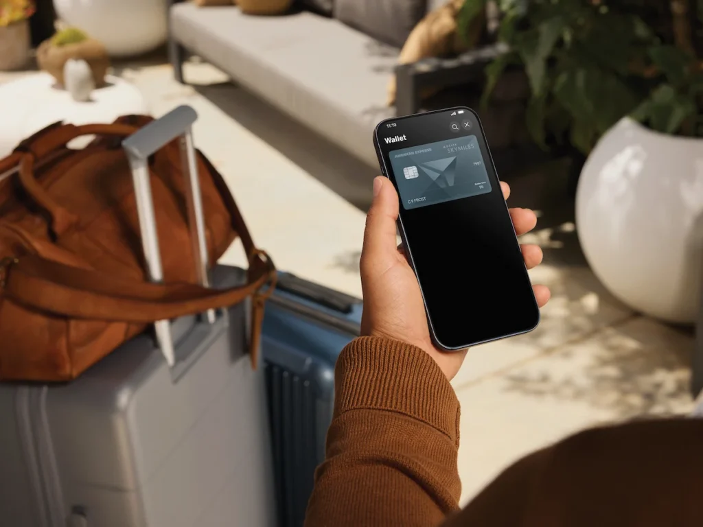 Hand holding smartphone displaying a Delta SkyMiles American Express card in a digital wallet