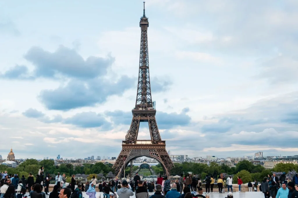 The Eiffel Tower towering over a crowd of people at Trocadero in Paris