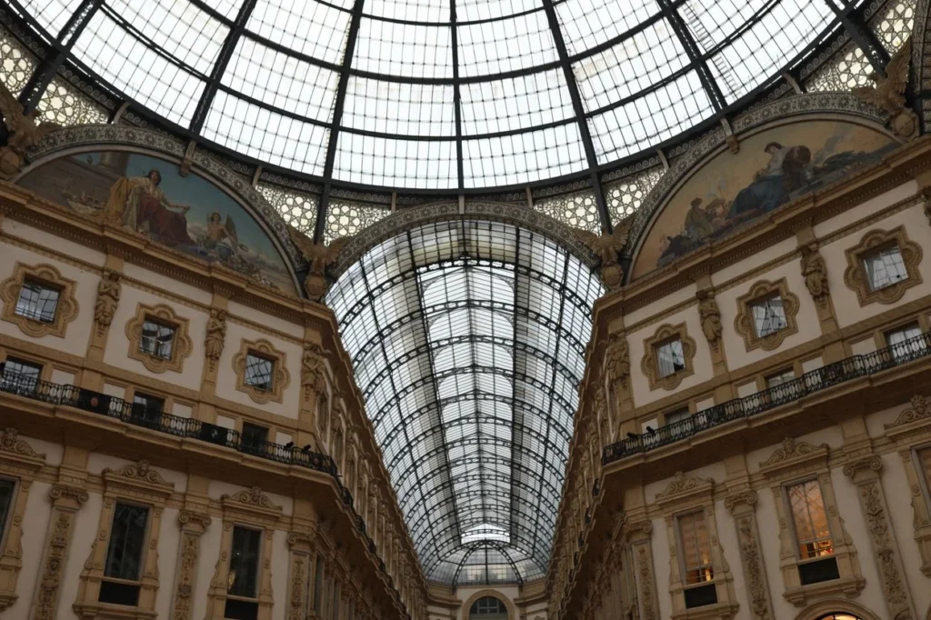 The intricate iron and glass dome ceiling of the Galleria Vittorio Emanuele II in Milan