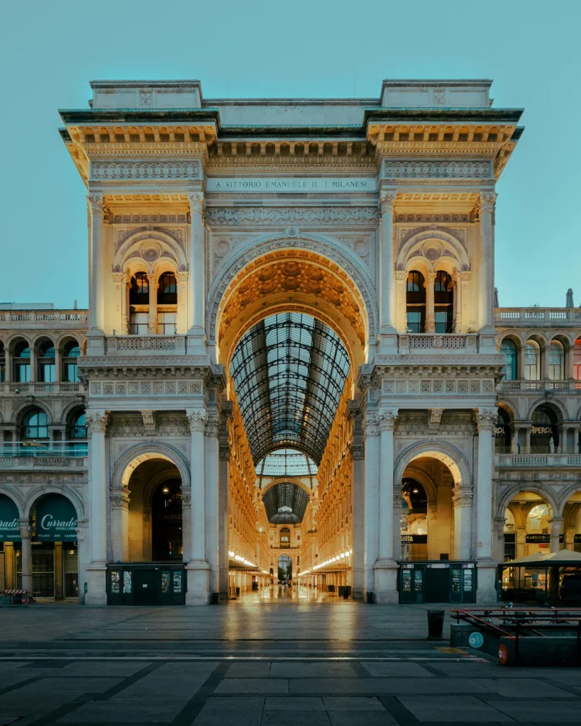 The monumental stone archway of the Galleria Vittorio Emanuele II in Milan