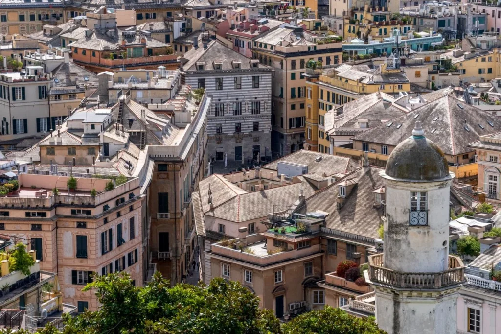High angle view of dense historic stone buildings and rooftops in Genoa, Italy