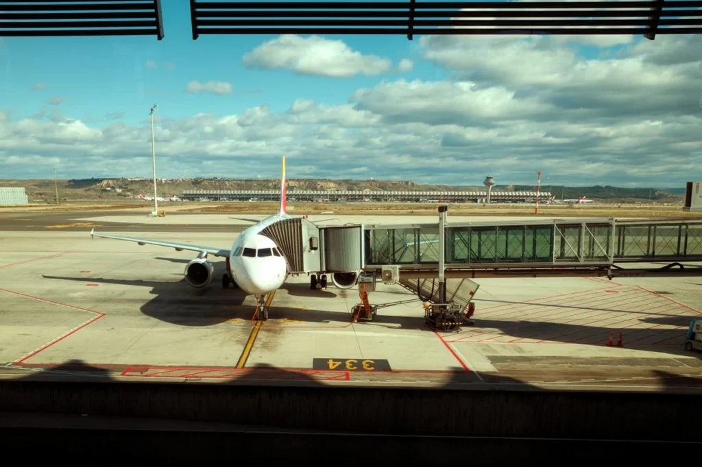 An Iberia airplane connected to a jet bridge at Madrid-Barajas Airport