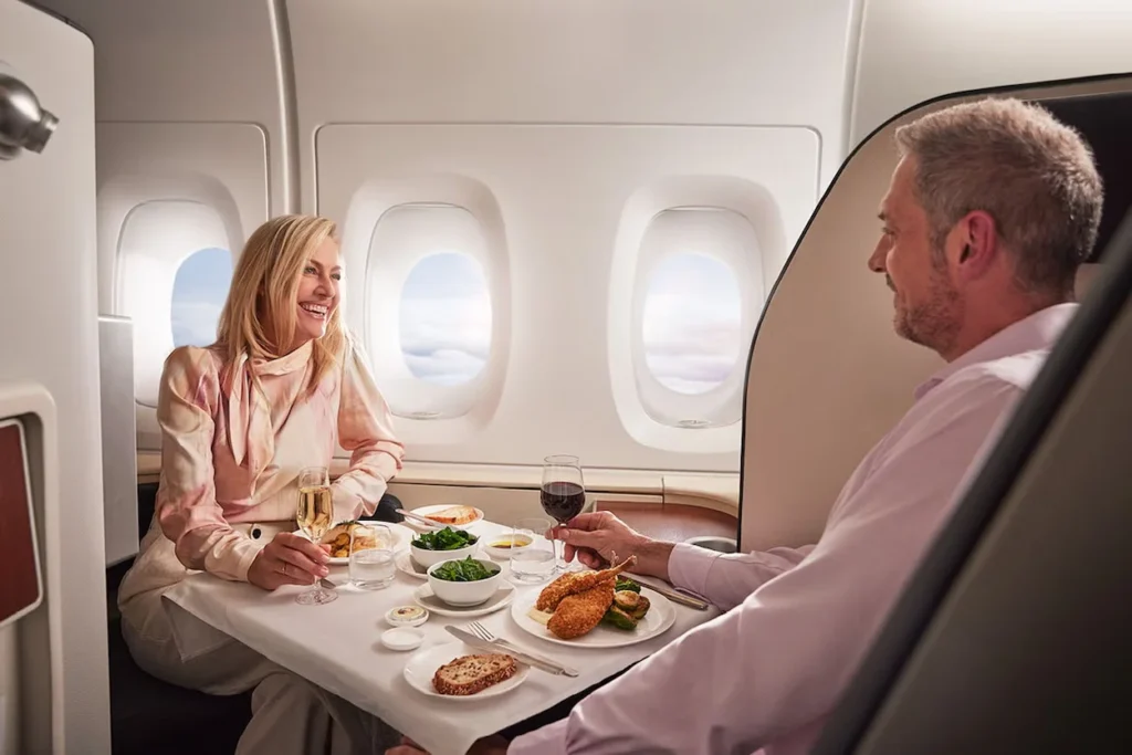 Couple dining together face-to-face inside a private Qantas Airways first-class suite