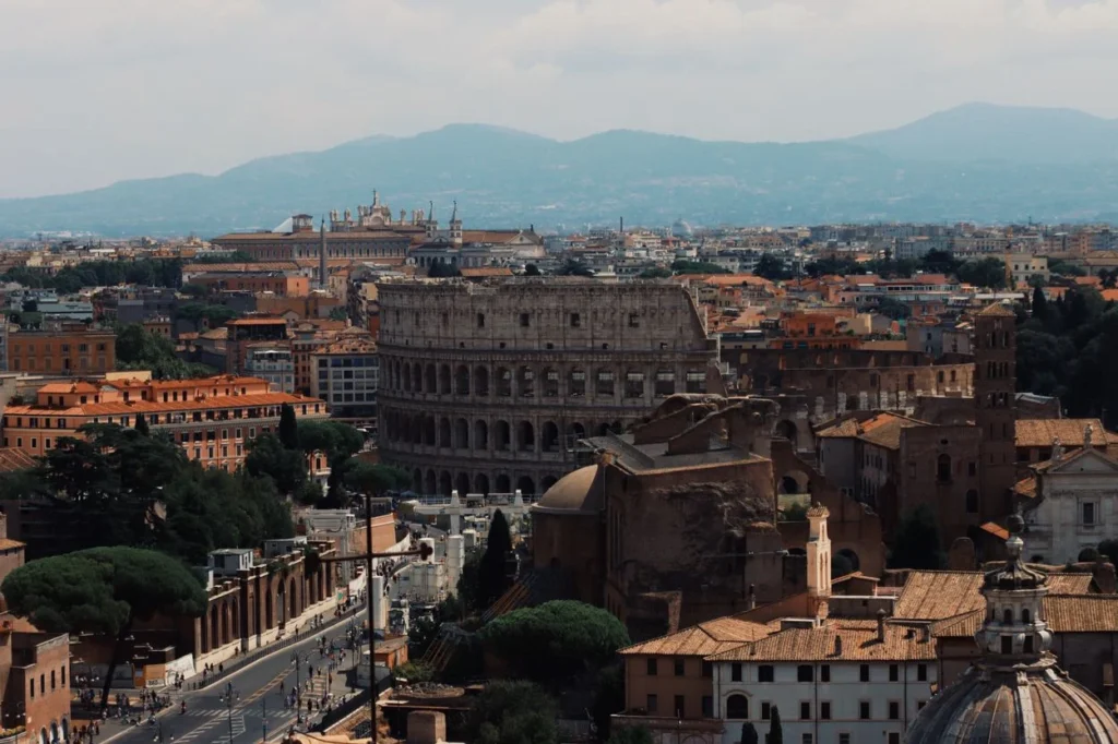The ancient Colosseum standing prominent within the historic cityscape of Rome