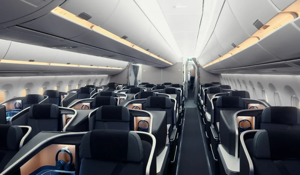 SAS business class cabin featuring modern charcoal seats with wooden privacy walls