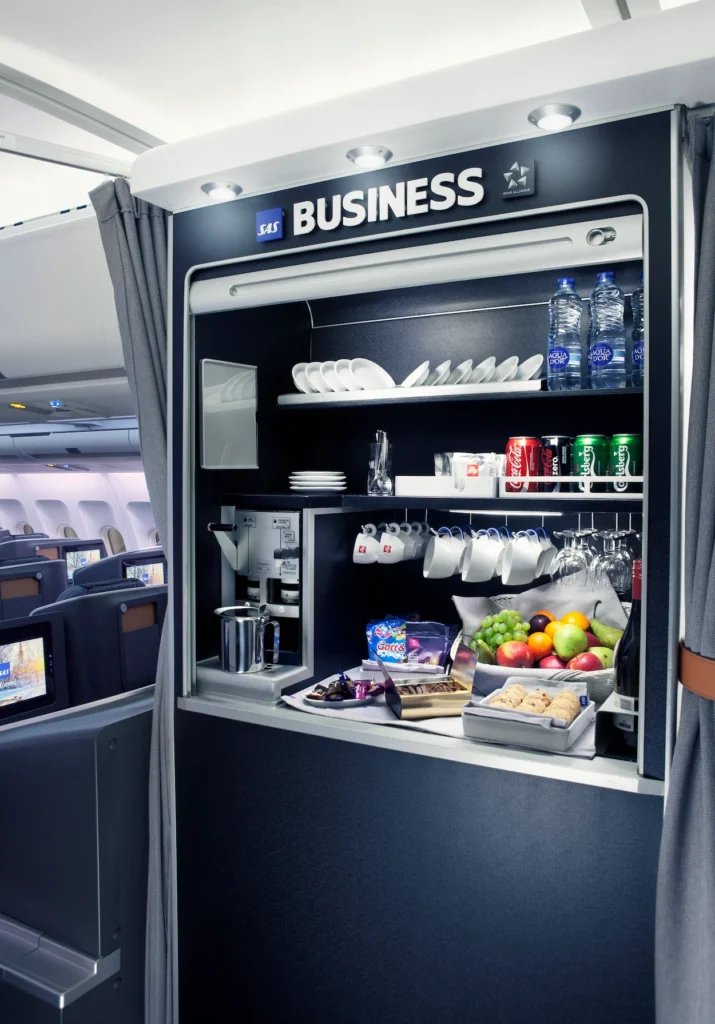 An onboard SAS Business class snack bar stocked with drinks, fresh fruit, and pastries