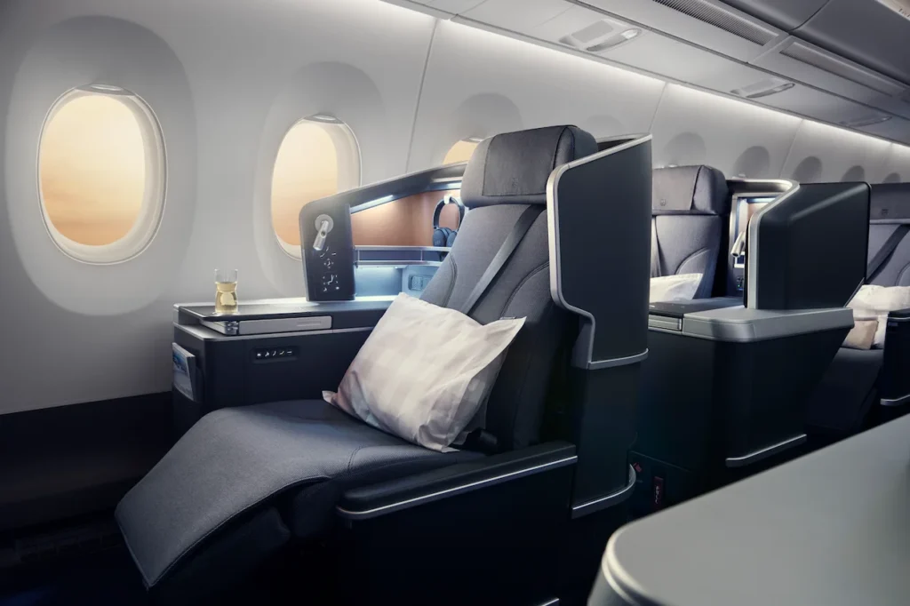 SAS business class window seat with a pillow and headphones by airplane windows