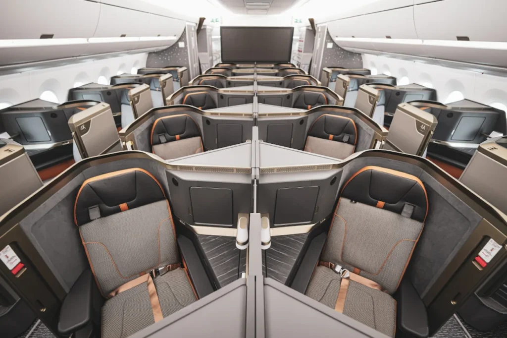 Starlux Airlines Airbus A350 business class cabin with herringbone pods and orange accents