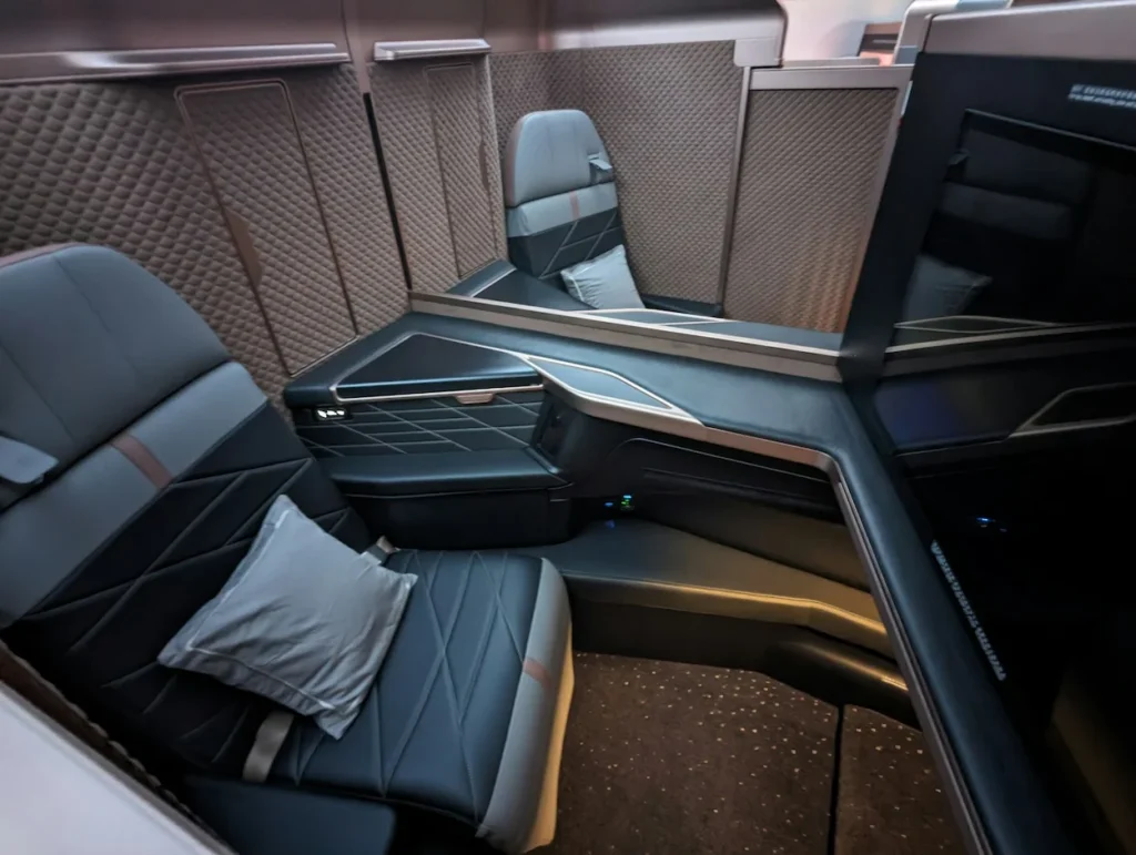 Starlux Airlines first-class suite with dark leather seating and privacy partitions